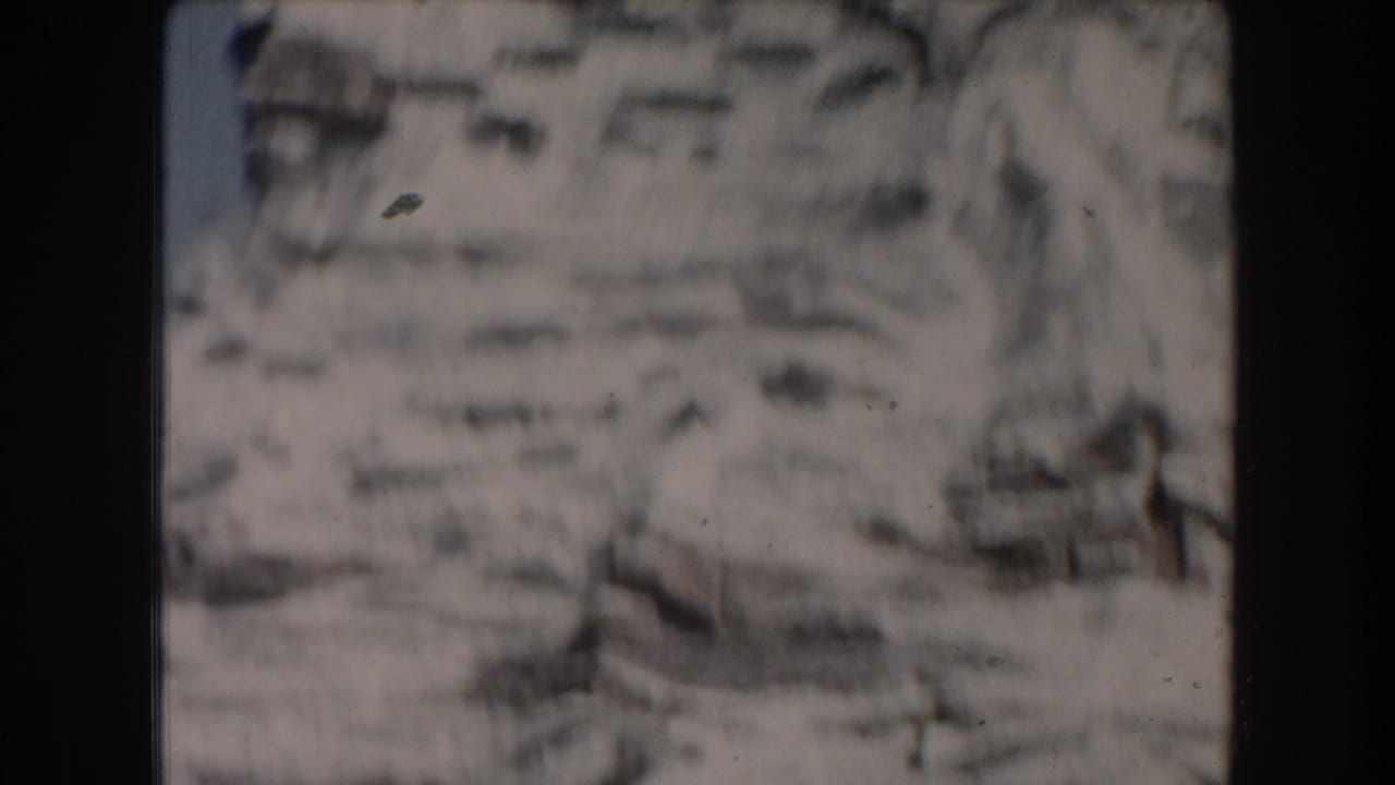 Soft, distant view of rocky terrain and water blurred by motion or focus.