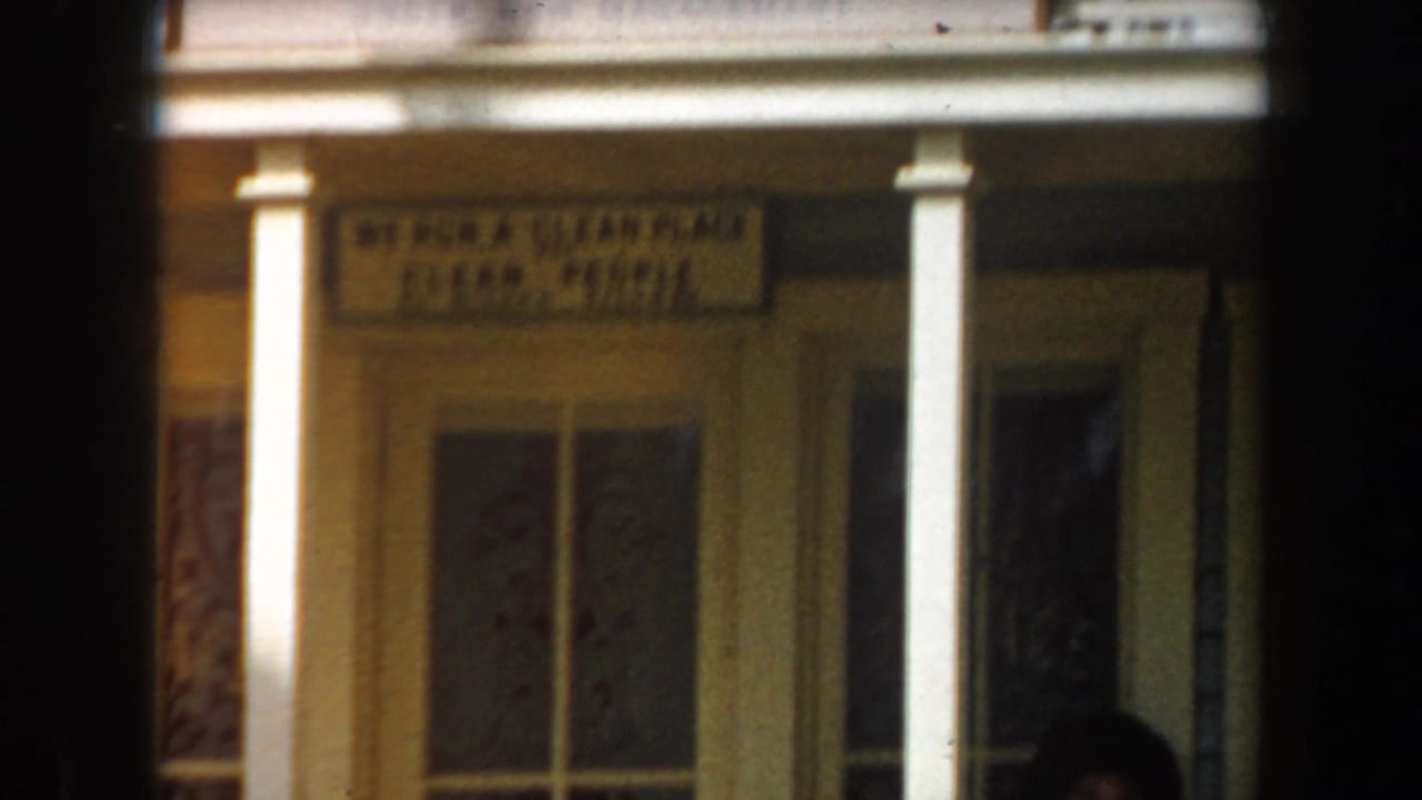 Storefront entrance with porch columns and a sign reading entertainment.
