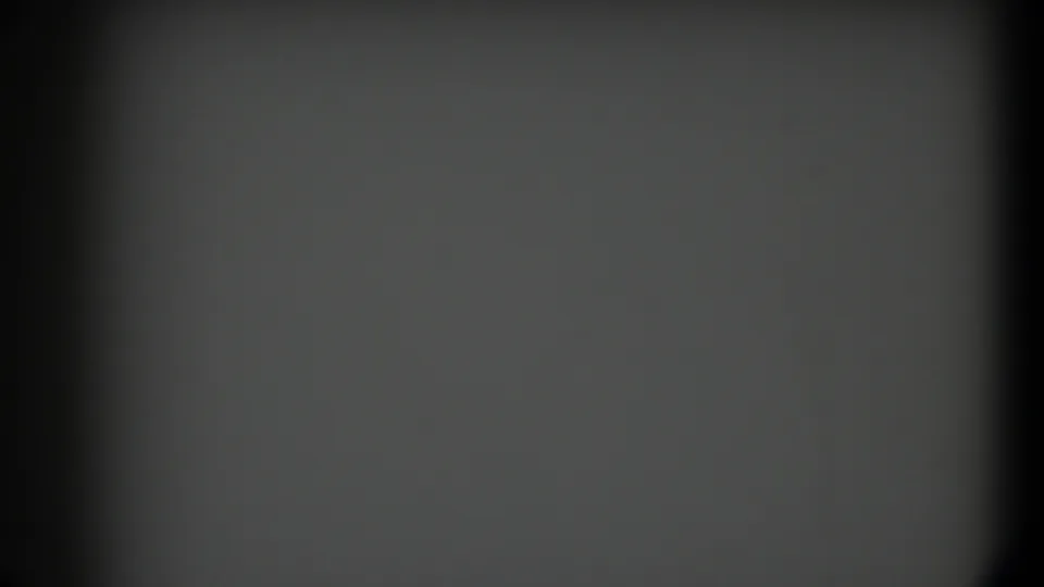 1958 Texas 8mm frame showing a blank gray field with grain, dark rounded edges, and a central vertical shadow.