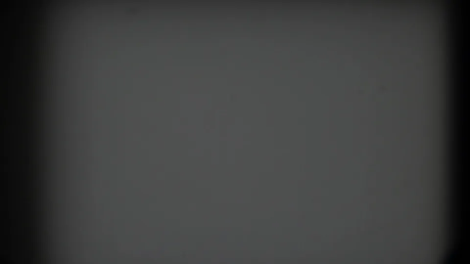 1958 Texas 8mm frame showing a blank gray lower-left panel with dark vignetting, grain, and faint surface marks.
