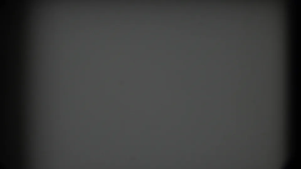 1958 Texas 8mm frame with a static blank gray field, dark rounded borders, subtle dust, and a soft vertical shadow at the left.