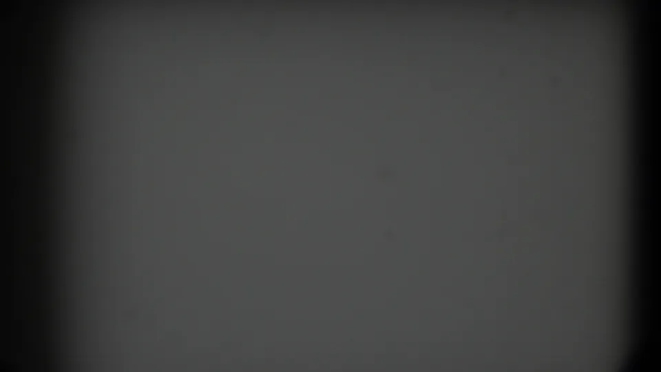 Dark, soft 8mm frame from the 1958 Texas clip with gray exposure area, heavy borders, and minimal visible detail.