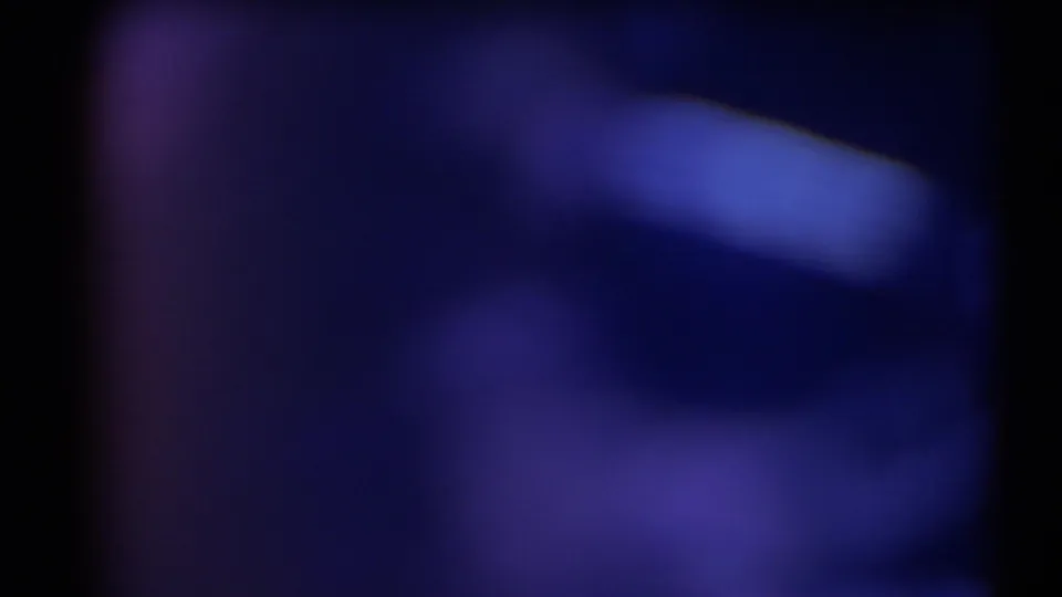 Soft 1958 Texas 8mm view with deep blue tones and a pale diagonal shape suggesting distant shoreline or terrain.