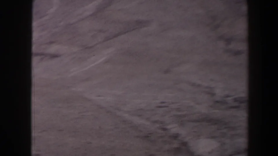 1958 Texas 8mm frame looking over a dry desert floor with low ridges, muted color, and soft home-movie focus.