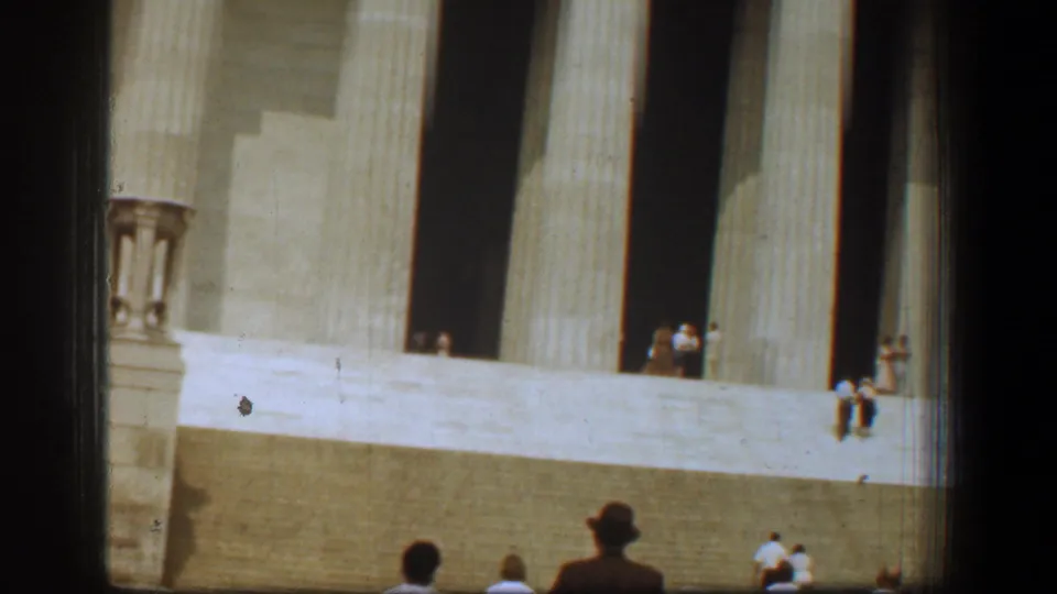 1961 Washington, DC home-movie view of the Lincoln Memorial steps, tall columns, and visitors seen from a distance.