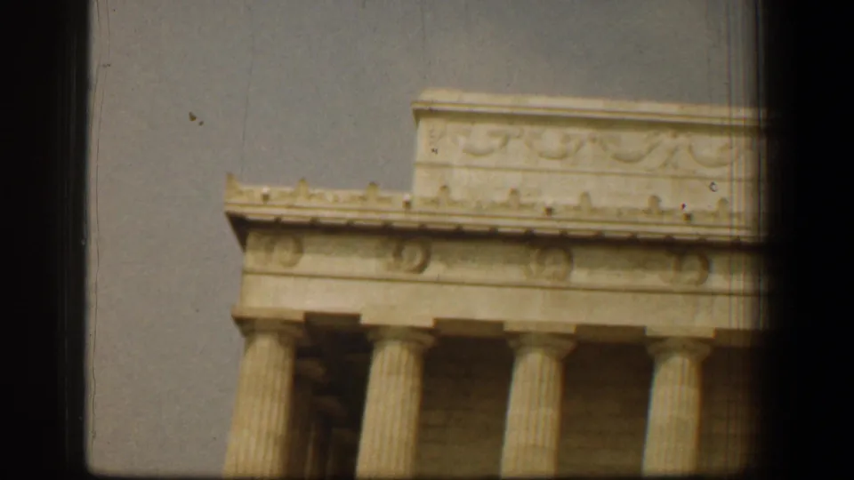 Close 8mm view of the Lincoln Memorial facade in Washington, DC, with columns and carved upper stonework.