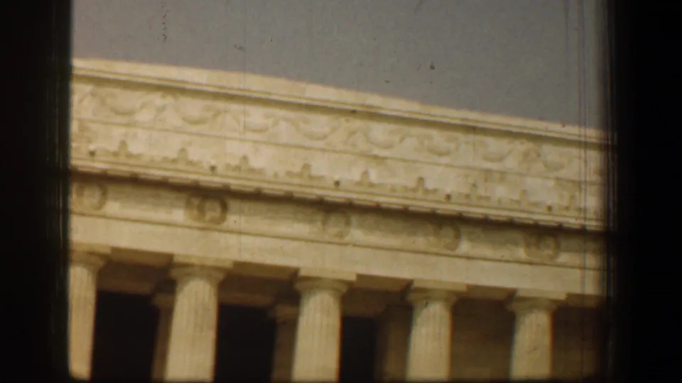 1961 8mm view of the Lincoln Memorial in Washington DC, with classical columns and decorative stonework framed by film-gate edges.