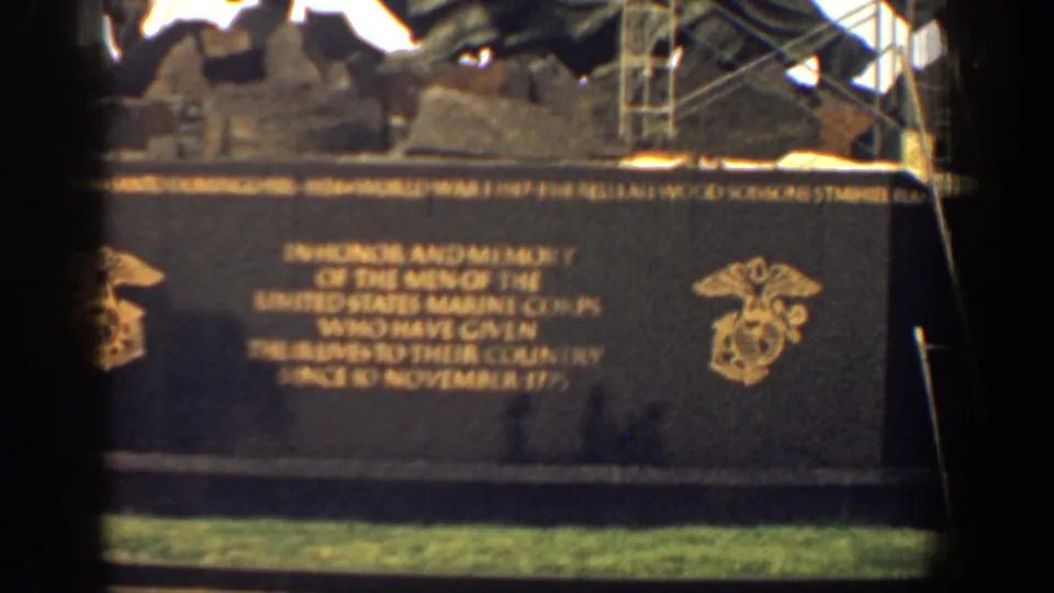 Washington DC Marine Corps War Memorial base inscription visible in a 1961 8mm frame, with emblems and sculpture above.