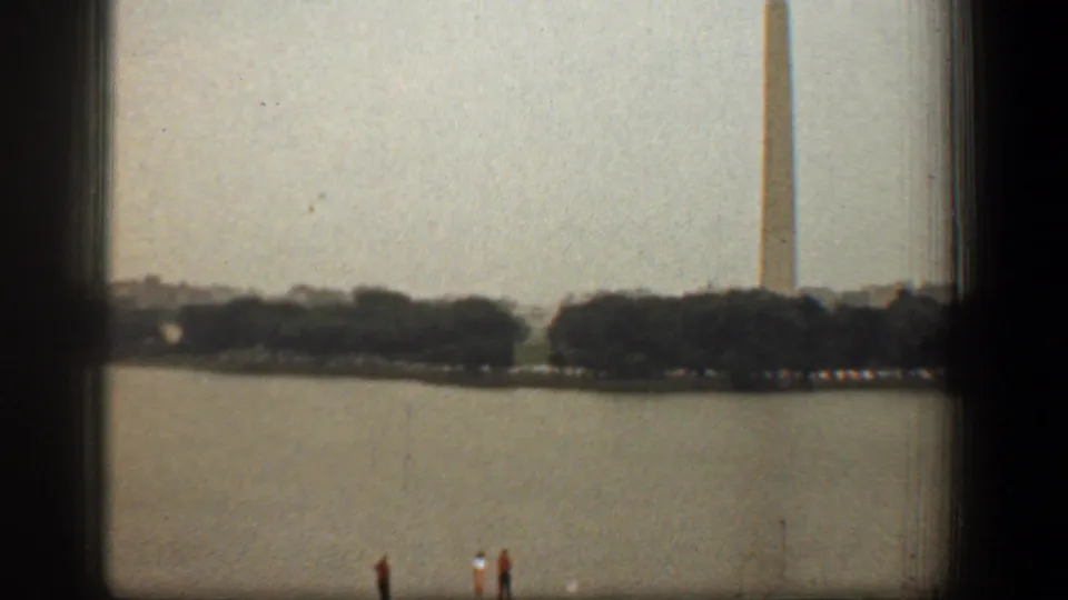 Washington Monument and tree-lined water view seen from a museum window in 1961 Washington DC home-movie footage.