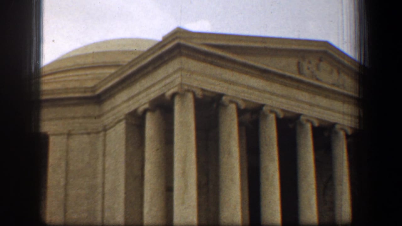 1961 8mm frame from Washington, DC, showing a closer visitor view of the Jefferson Memorial dome, pediment, and columns.