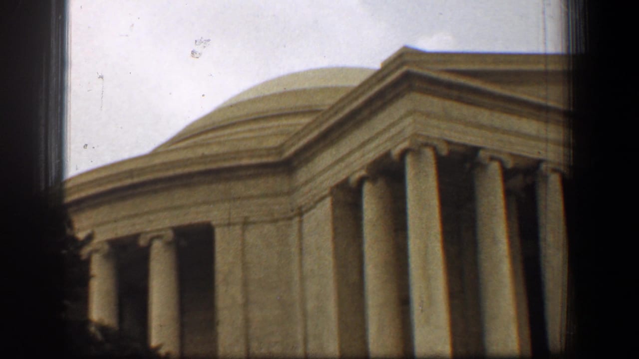 Late-frame 1961 view of the Jefferson Memorial in Washington, DC, with dome, pediment, columns, cloudy sky, and 8mm edge shadowing.
