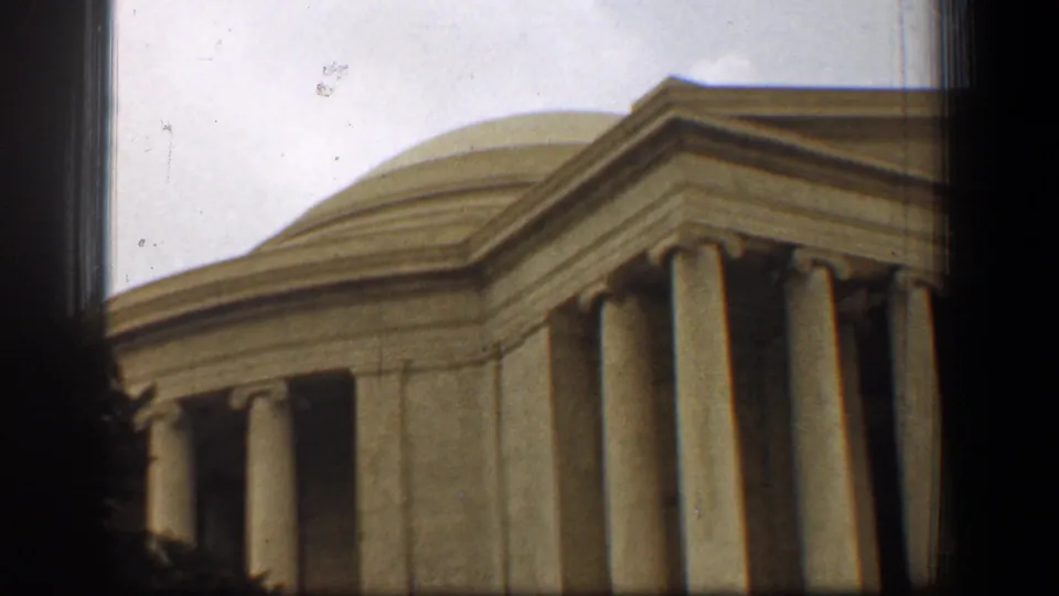 Late-frame 1961 view of the Jefferson Memorial in Washington, DC, with dome, pediment, columns, cloudy sky, and 8mm edge shadowing.