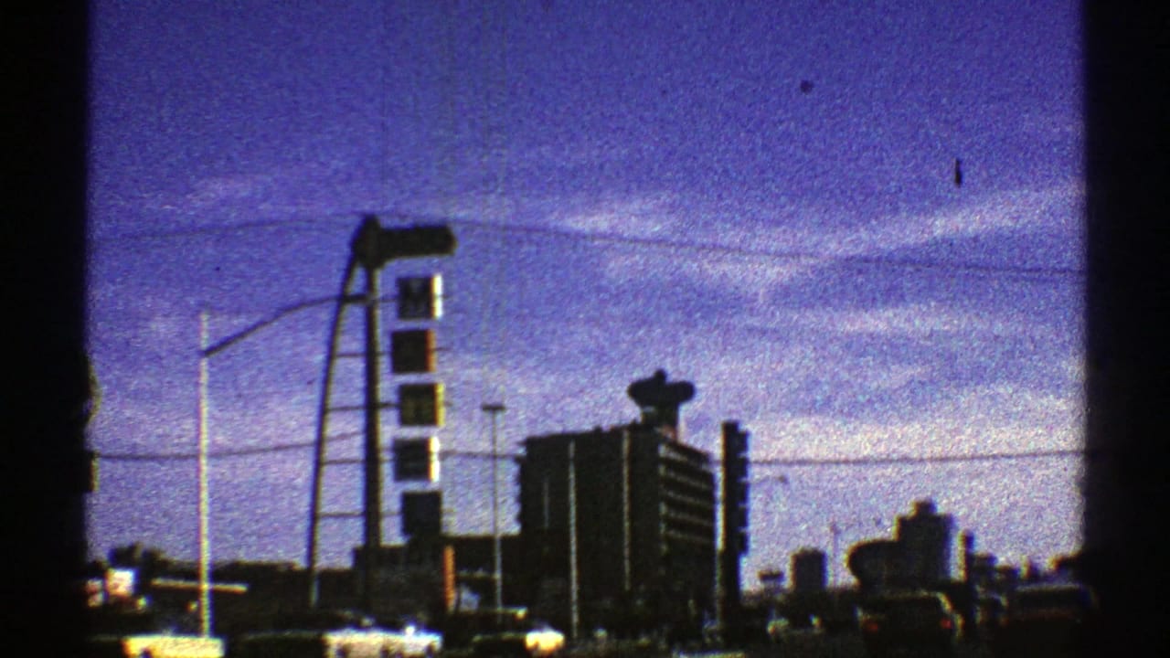 Tall roadside sign structure and Shell station area seen from a moving vehicle.