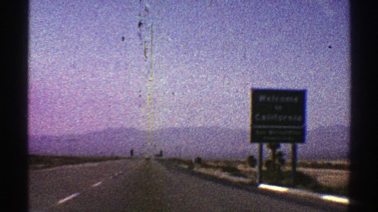 1969 8mm road footage near the Nevada-California border, with a Welcome to California sign beside the highway.