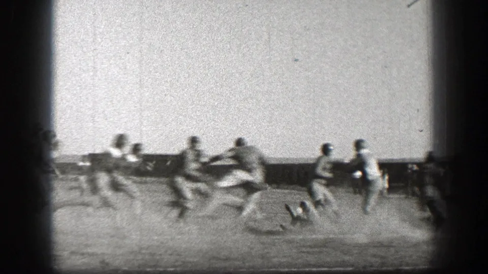 A late play in the Washington 1938 football clip shows players closing in for a tackle, with dust rising around them.