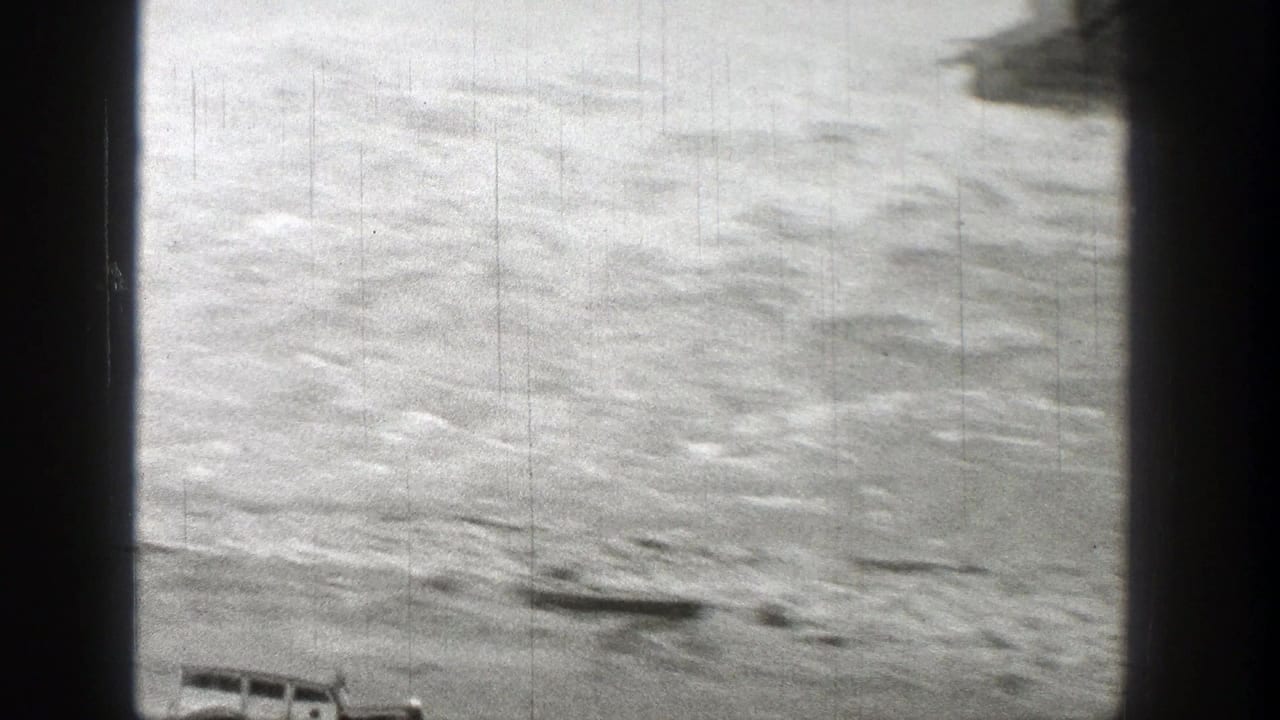 1938 Washington 8mm frame showing a bright, rippled water surface with heavy grain and dark film borders.