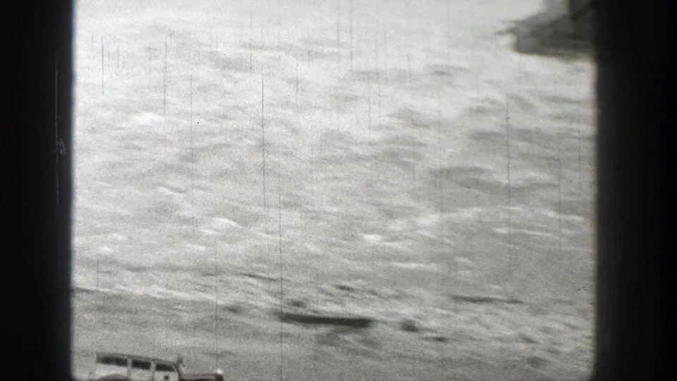 1938 Washington 8mm frame showing a bright, rippled water surface with heavy grain and dark film borders.