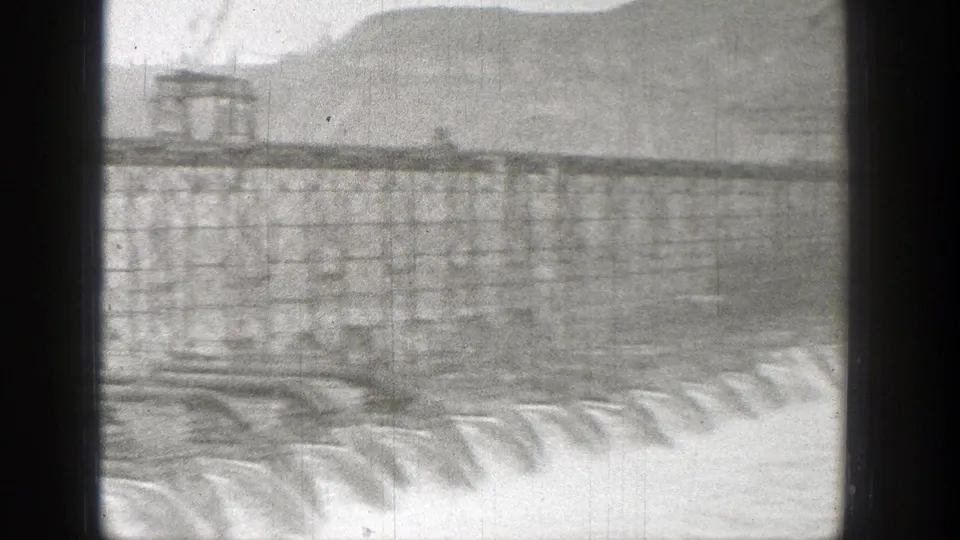 Black-and-white Washington construction view with a long elevated structure above a row of cascading water.