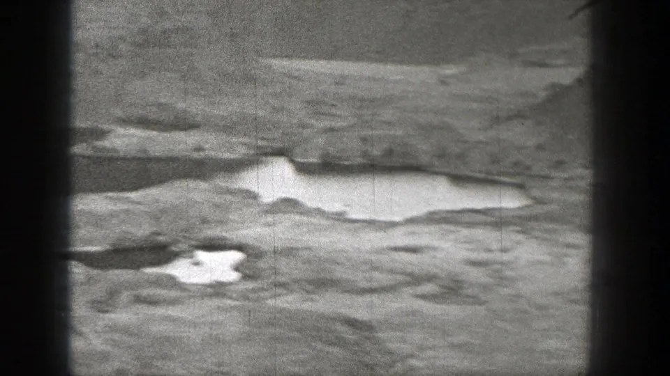 Rugged Washington landscape in 1938 home-movie footage, showing pale pools across rough ground.