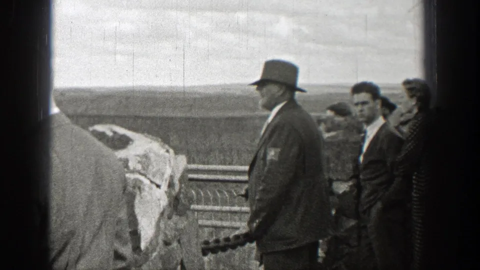 A small group, including men in hats, stands at a Washington overlook in 1938 8mm footage.