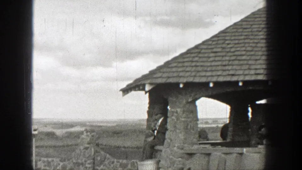 The 1938 Washington footage shows the stone pavilion from closer view, with its roof, columns, railing, and open landscape beyond.