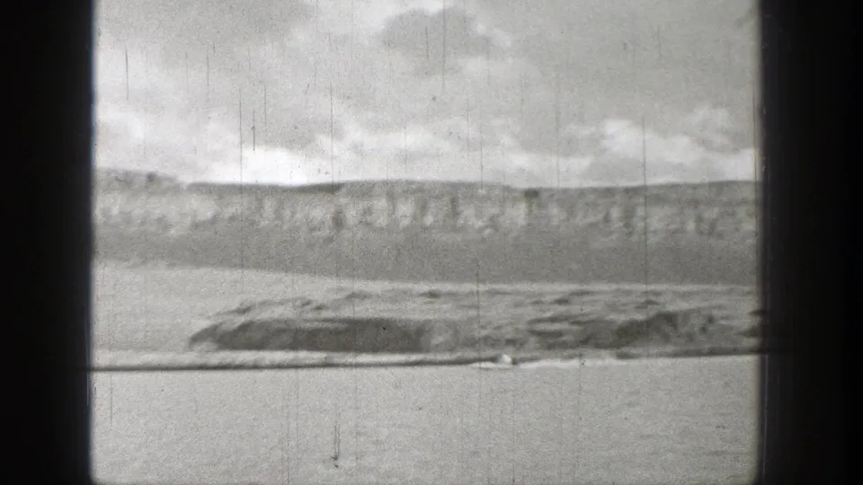 Wide 1938 Washington lake view with a small motorized craft near the lower frame, low shoreline, and distant hills.