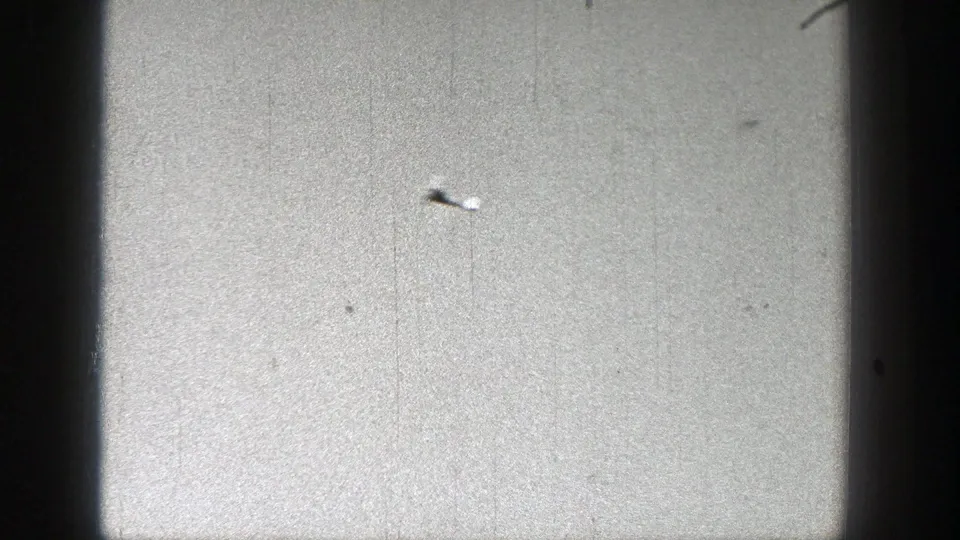 A small toy glider appears in the upper left of a bright sky in 1938 Washington 8mm home-movie footage.