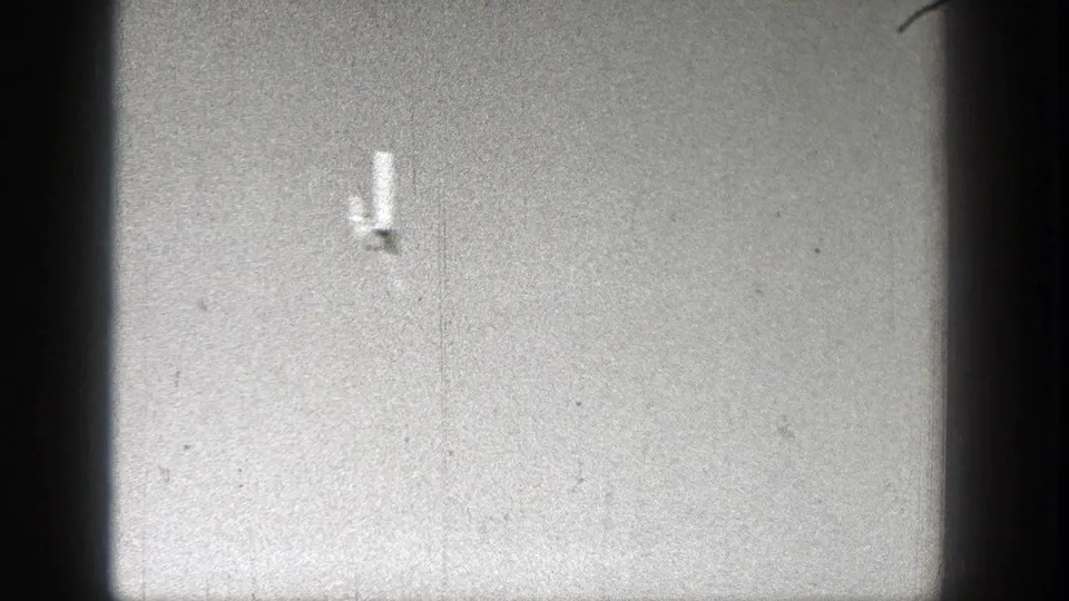 A small aircraft crosses the sky in metadata-supported 1938 Washington home-movie footage, framed by dark 8mm film edges.