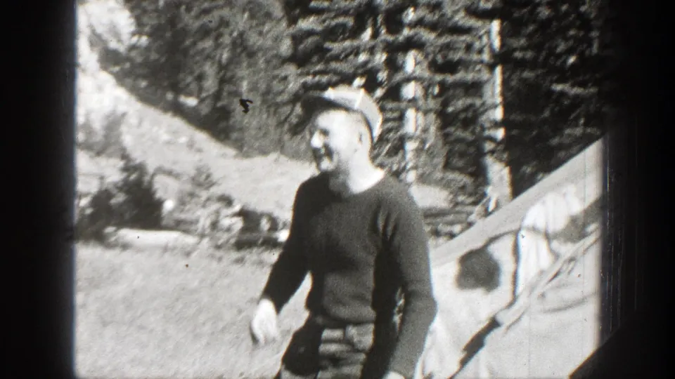 Adult man in a cap walks on a sloped dirt path in a wooded California setting, filmed in 1938.