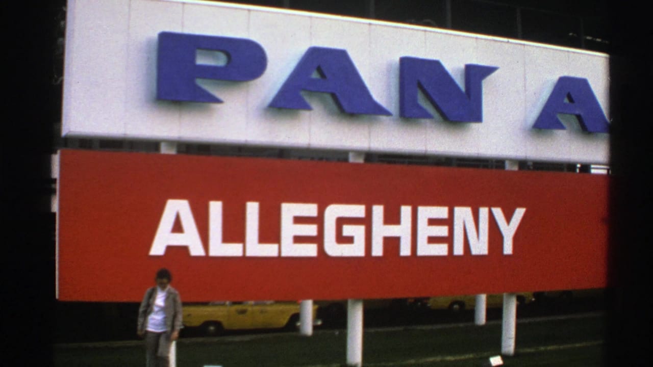 Woman near the center foreground below the red Allegheny airline sign.