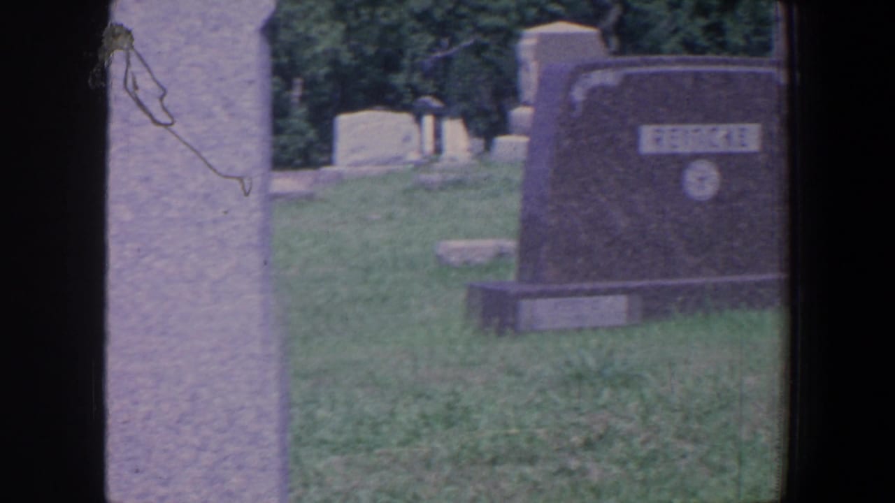 REINCKE gravestone beside a tall light-colored marker in a cemetery.