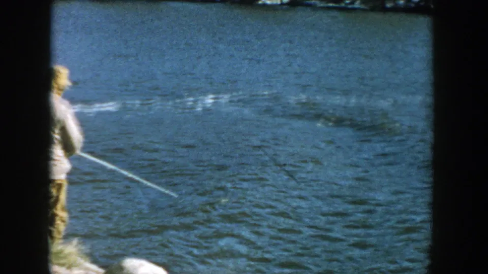 The final frame looks over the man's shoulder as his fishing line reaches into the river, with the bridge mostly out of view.