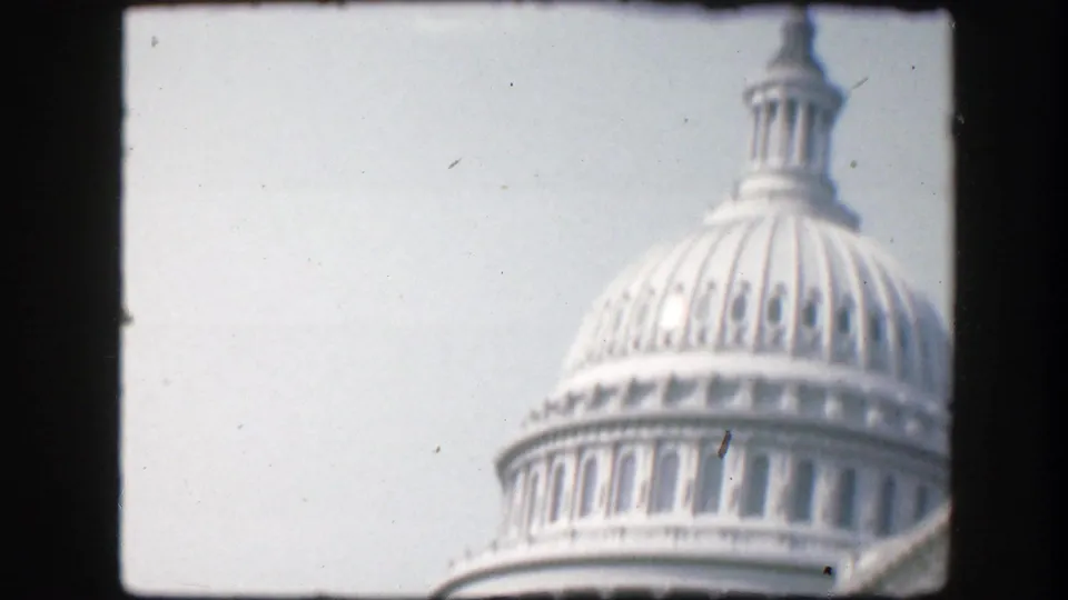 1945 Washington D.C. home-movie frame showing the upper U.S. Capitol dome and cupola in soft focus.