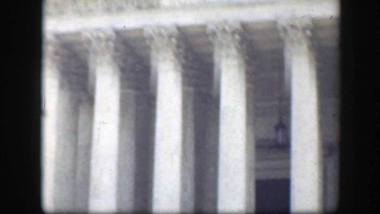 Close view of tall stone columns on a monumental building facade.