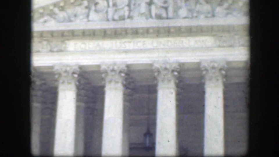 Washington DC civic facade with Corinthian columns and the EQUAL JUSTICE UNDER LAW inscription visible near the top of the 8mm frame.
