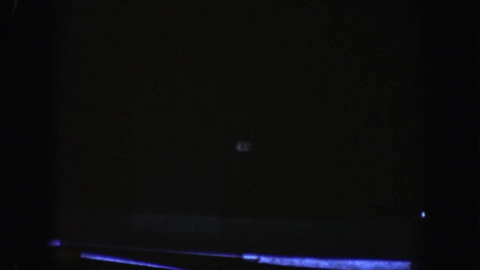 Inside the Aspen-area highway tunnel, the frame drops into near darkness with only faint road and light details visible.