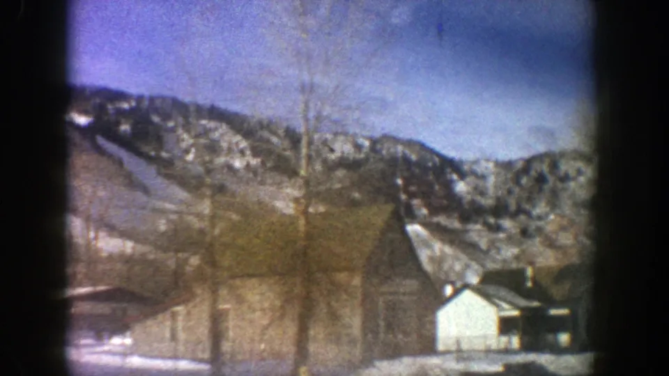 Aspen, Colorado, 1961 home-movie view of bare trees, simple structures, and snow-covered slopes in winter light.