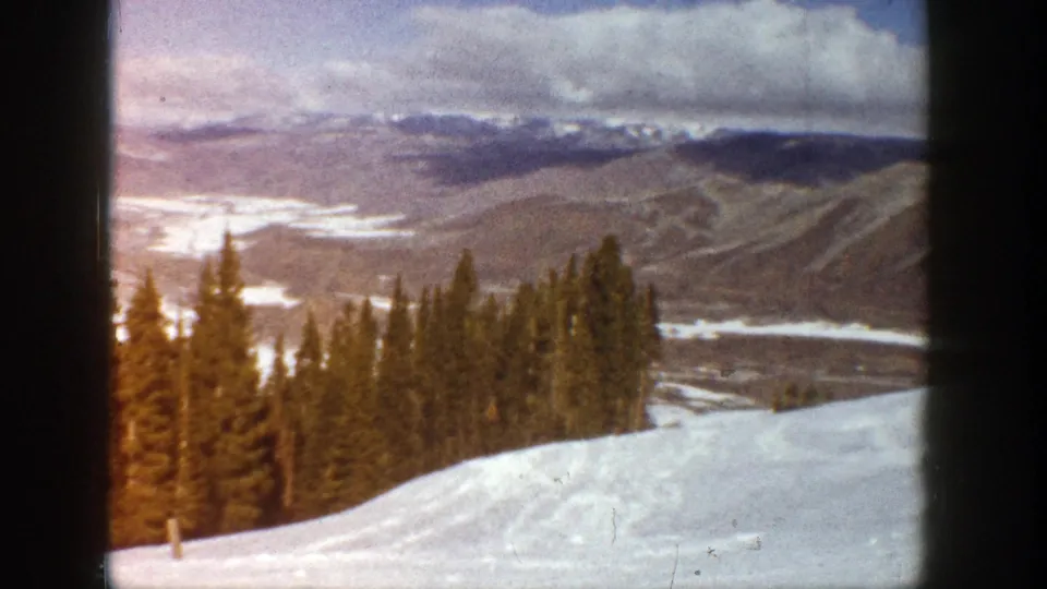 Aspen, Colorado winter landscape on 8mm film, with snow, evergreens, and distant valley slopes.