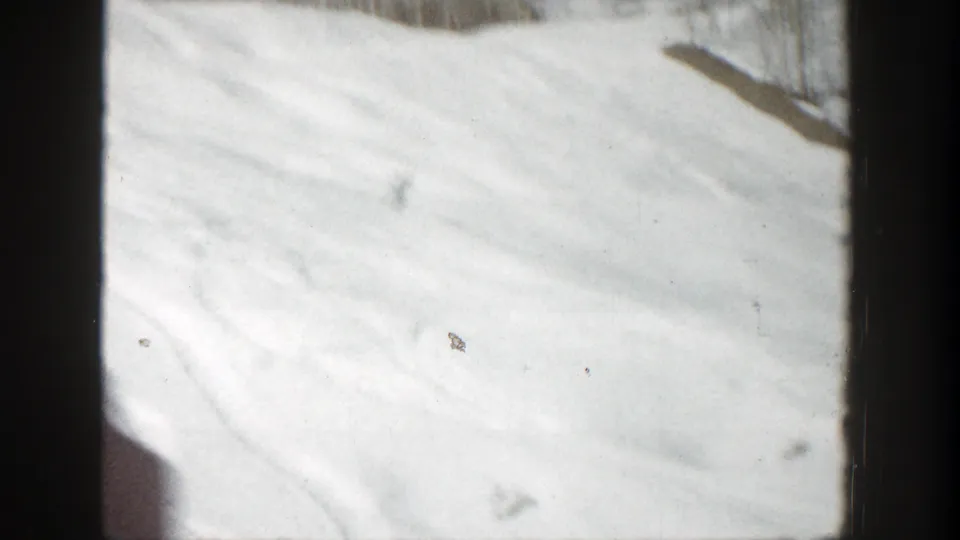 Bright 1961 Aspen ski-slope frame with faint tracks, soft focus, and little visible human detail.