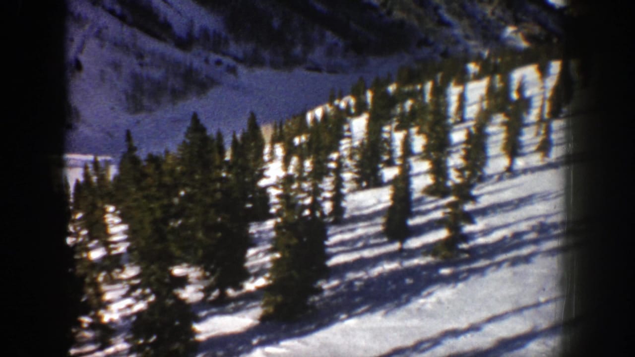Aspen winter landscape frame from 1961 showing clustered evergreens on bright snow with dark 8mm frame edges.