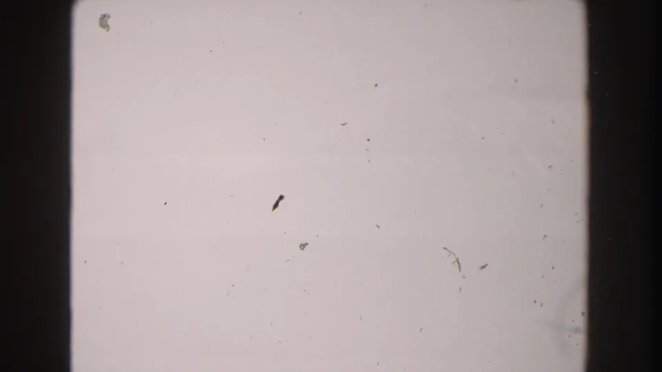 1960s Italy 8mm home-movie frame appearing blank or overexposed, with dark edge borders and visible dust.