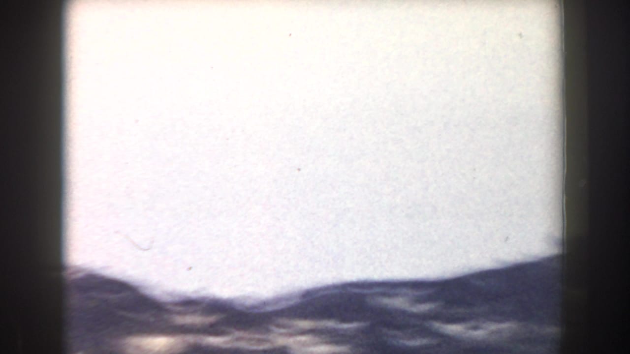 Pale sky above a blurred line of distant hills.