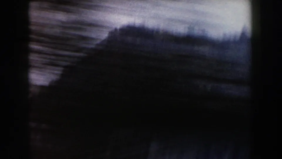 Motion-blurred roadside trees and dark foreground shapes pass across a 1960 Italy travel frame.