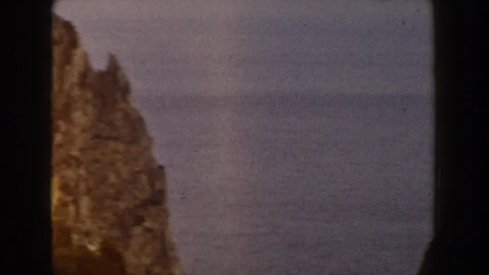 Soft 8mm view of an Italian rocky outcrop, partly obscured by the contact-sheet divider and framed against a hazy backdrop.