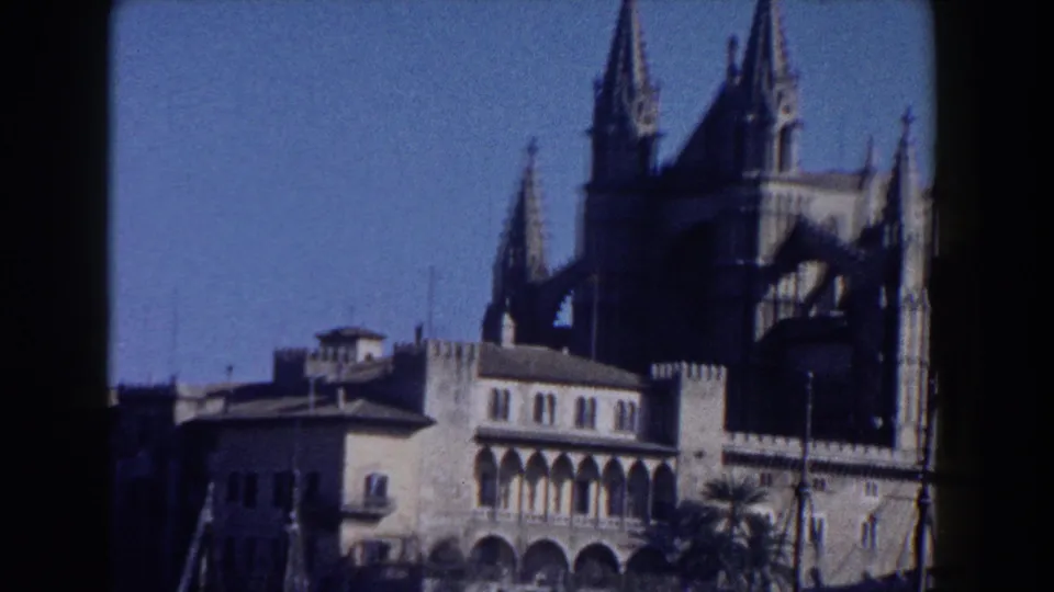 1960 Italy 8mm view of Gothic-style church towers and arched stone structures framed from below.