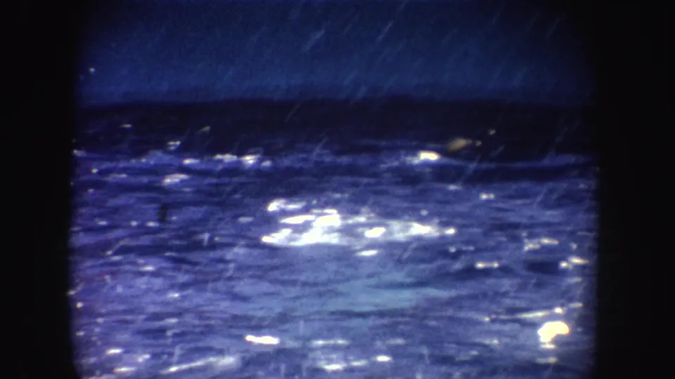 1962 California 8mm frame showing rippling pool water with bright reflections, blue color cast, and visible film wear.