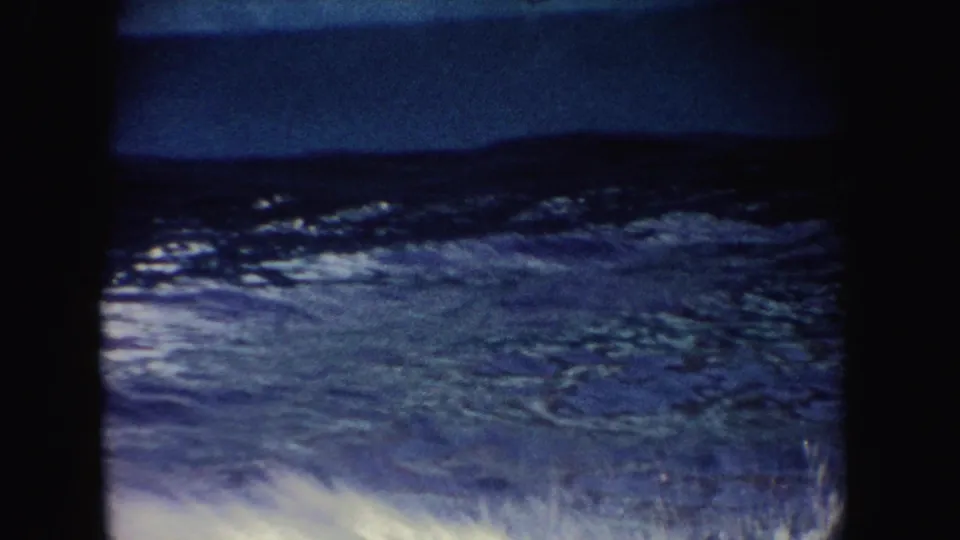 1962 California 8mm footage shows dark blue pool water and splash patterns near the edge of a marine performance setting.