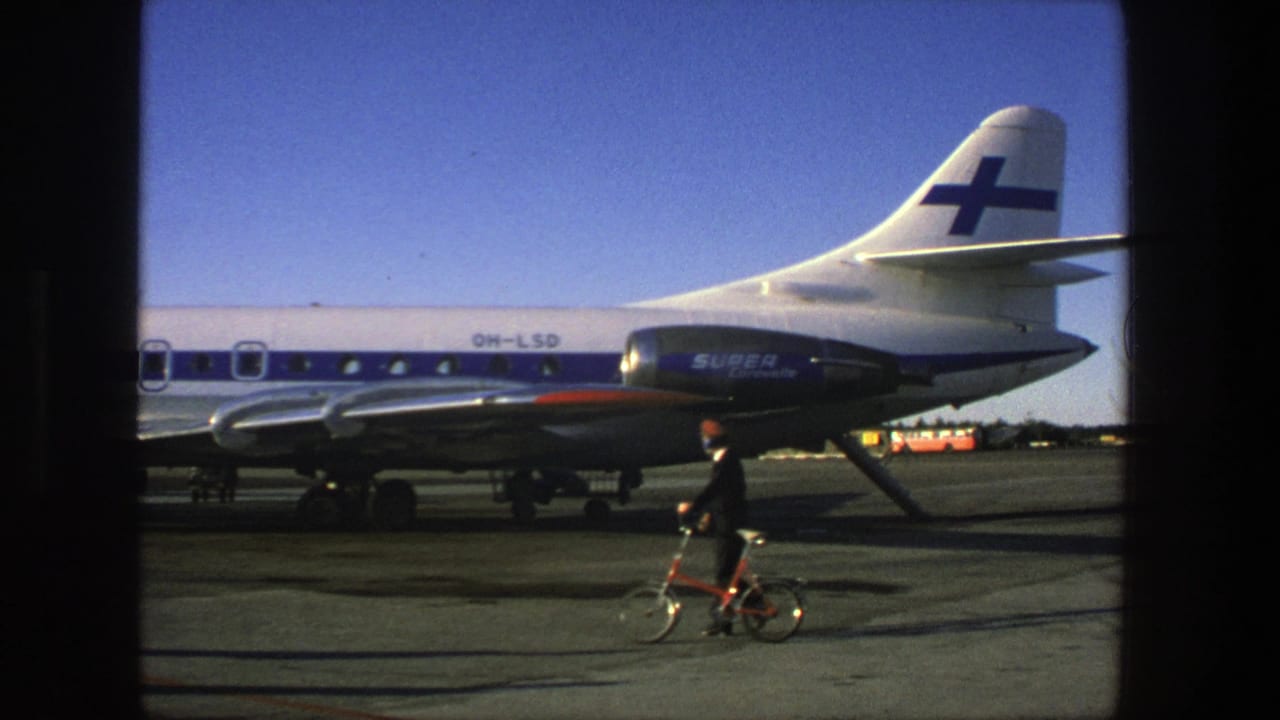 Finnair Super Caravelle on tarmac with a man and small bicycle in the foreground.