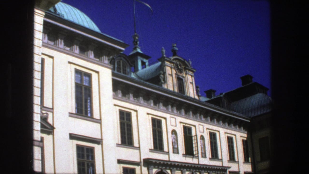 Historic pale facade with tall windows, copper roof details, and dark 8mm frame edges.