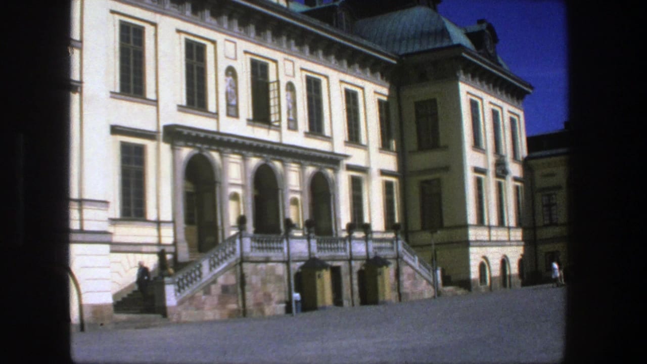 1975 Stockholm frame of the building entrance, showing arched openings, symmetrical windows, stone stairs, and distant visitors near the facade.